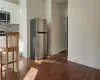 Kitchen with white cabinetry, dark wood-type flooring, appliances with stainless steel finishes, and tasteful backsplash