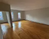 Spare room with a baseboard radiator and light hardwood / wood-style flooring