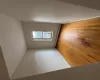 Empty room with baseboard heating and light hardwood / wood-style floors