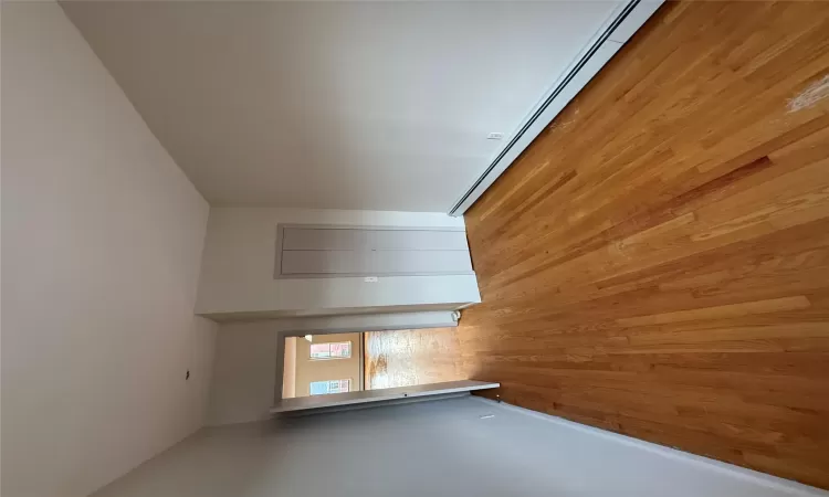 Unfurnished room featuring light hardwood / wood-style flooring and a baseboard radiator