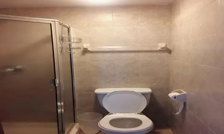 Bathroom with toilet and a shower with door