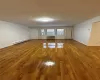 Spare room featuring a wall mounted AC, hardwood / wood-style floors, and a baseboard heating unit