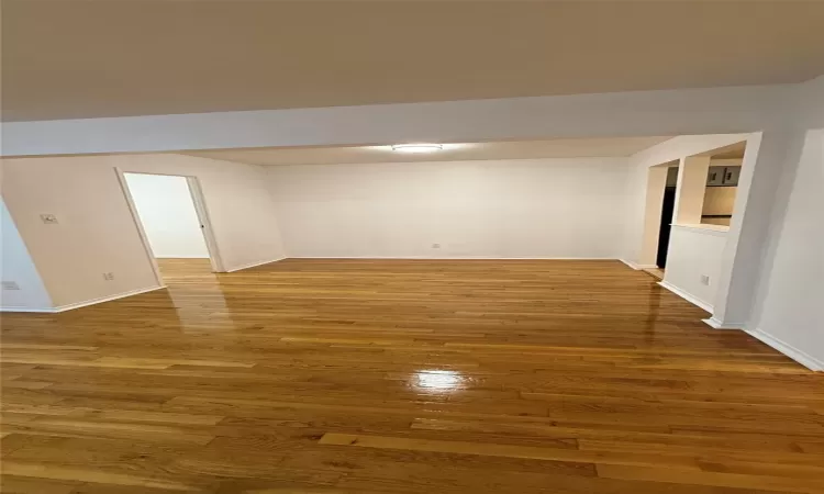 Spare room with dark hardwood / wood-style flooring and built in features