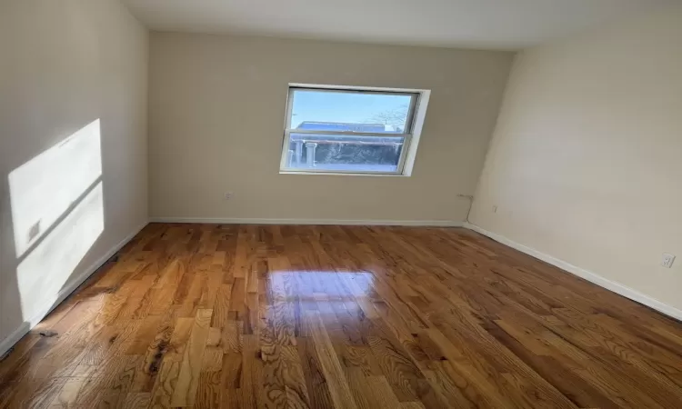 Unfurnished room featuring dark wood-type flooring