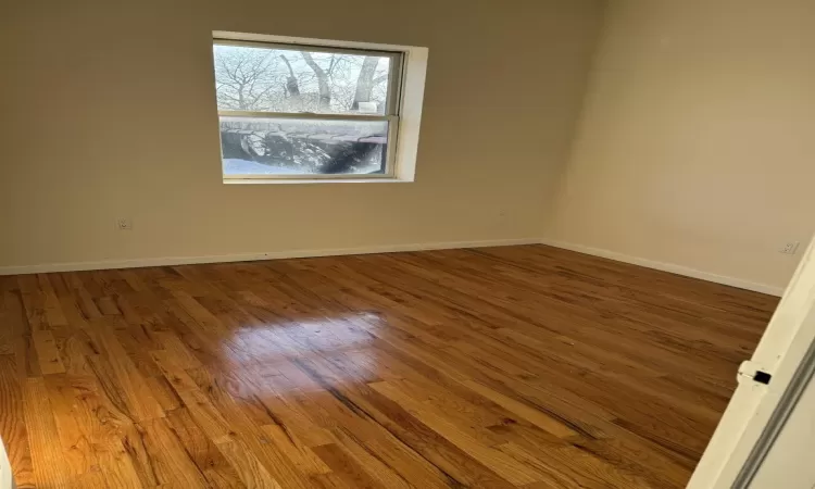 Empty room featuring hardwood / wood-style flooring