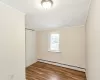 Empty room featuring plenty of natural light, light hardwood / wood-style floors, and baseboard heating