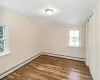 Unfurnished room with a wealth of natural light, light hardwood / wood-style floors, and baseboard heating