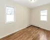 Unfurnished bedroom featuring ornamental molding, light wood-type flooring, and multiple closets