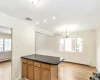 Kitchen featuring a baseboard radiator, kitchen peninsula, crown molding, decorative backsplash, and black appliances