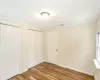 Unfurnished bedroom featuring a closet, light hardwood / wood-style flooring, baseboard heating, and ornamental molding