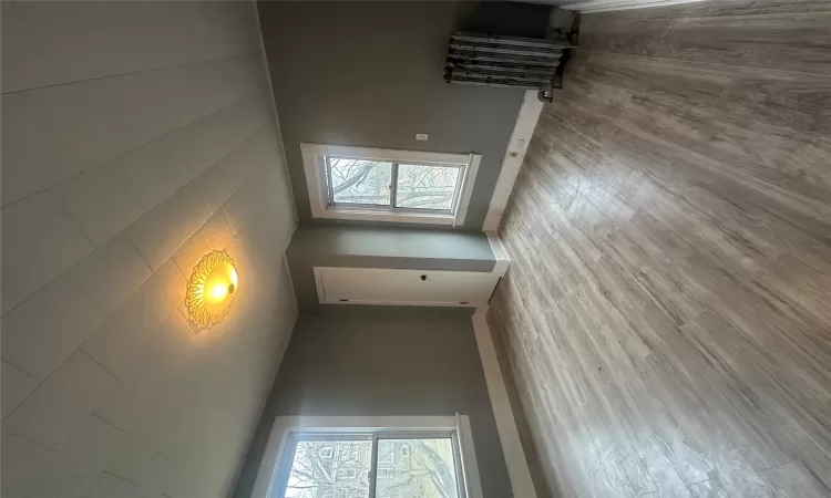 Spare room featuring hardwood / wood-style flooring and radiator heating unit