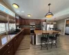 Kitchen featuring appliances with stainless steel finishes, sink, pendant lighting, a center island, and a breakfast bar area