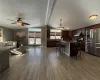 Kitchen featuring a kitchen bar, stainless steel refrigerator with ice dispenser, decorative light fixtures, a kitchen island, and lofted ceiling