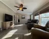 Living room featuring crown molding, vaulted ceiling, ceiling fan, a textured ceiling, and dark hardwood / wood-style flooring