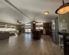 Kitchen with plenty of natural light, lofted ceiling, a kitchen bar, a kitchen island, and appliances with stainless steel finishes