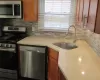 Kitchen with stainless steel appliances, tasteful backsplash, and sink