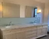 Bathroom with vanity, tile patterned floors, and backsplash