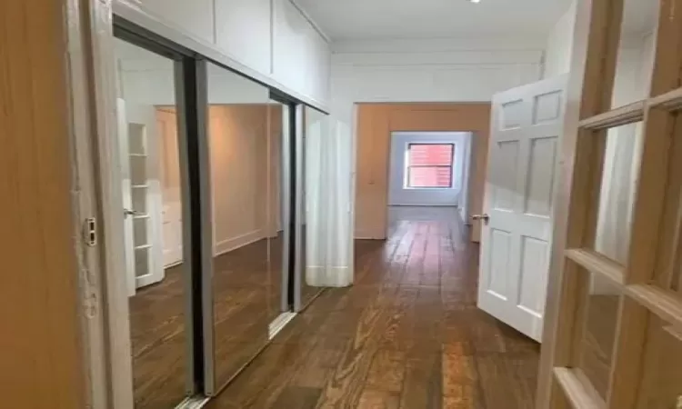 Hallway with dark wood-type flooring