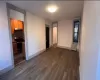 Unfurnished bedroom with a closet, radiator, and dark wood-type flooring