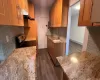 Kitchen featuring backsplash, dark wood-type flooring, range with electric cooktop, sink, and light stone countertops