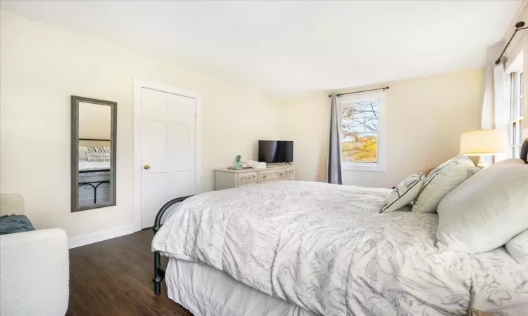 Bedroom with dark hardwood / wood-style floors