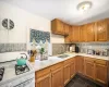 Kitchen featuring backsplash, white gas stove, sink, and dark tile patterned flooring