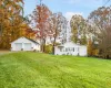 View of yard with an outdoor structure and a garage