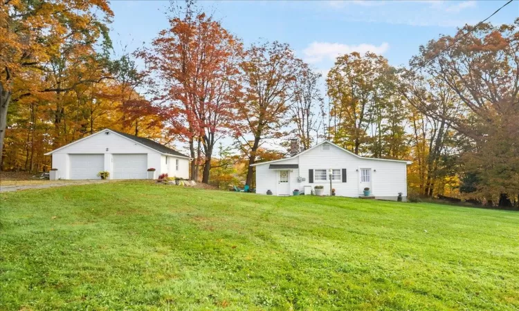 View of yard with an outdoor structure and a garage