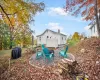 Rear view of property with a fire pit