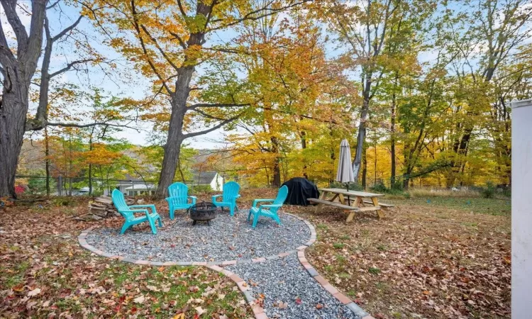 View of yard with an outdoor fire pit