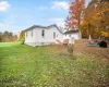 Back of house featuring a lawn