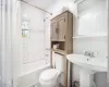 Full bathroom featuring shower / bath combo, toilet, and sink