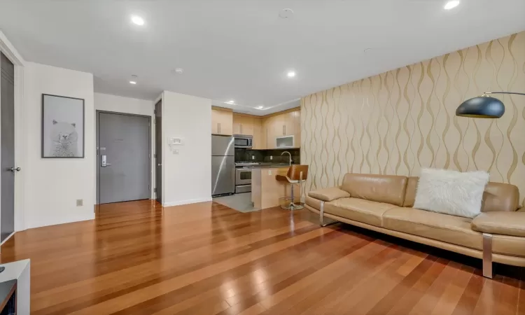 Living room featuring sink and light wood-type flooring