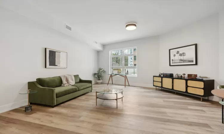 Living room with light hardwood / wood-style floors