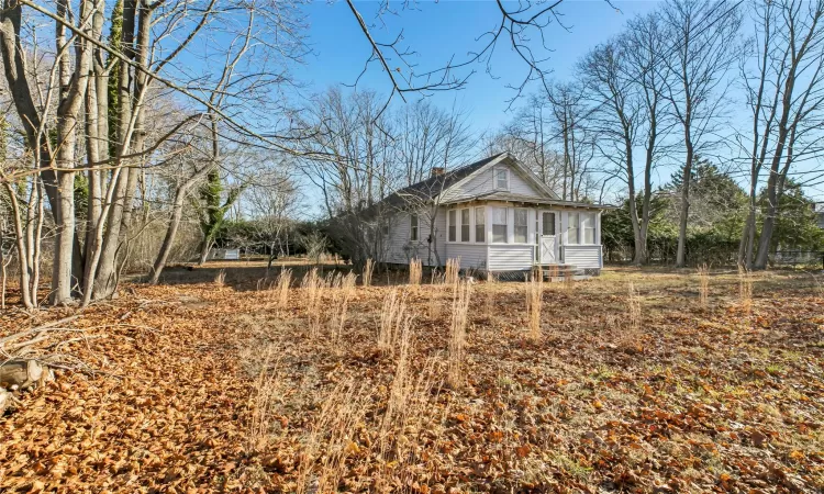 View of side of property with a sunroom