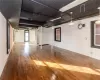 Basement with hardwood / wood-style flooring and brick wall