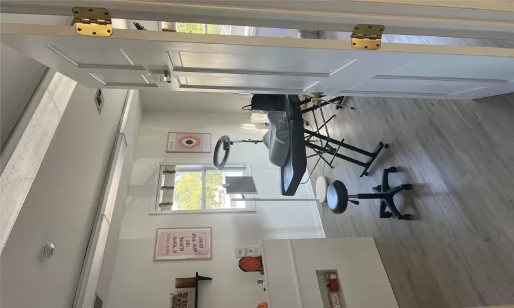 Exercise room with hardwood / wood-style floors