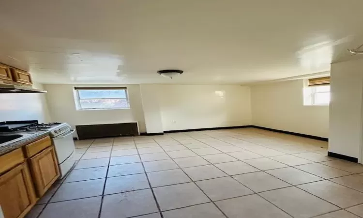 Kitchen featuring gas range gas stove and light tile patterned flooring