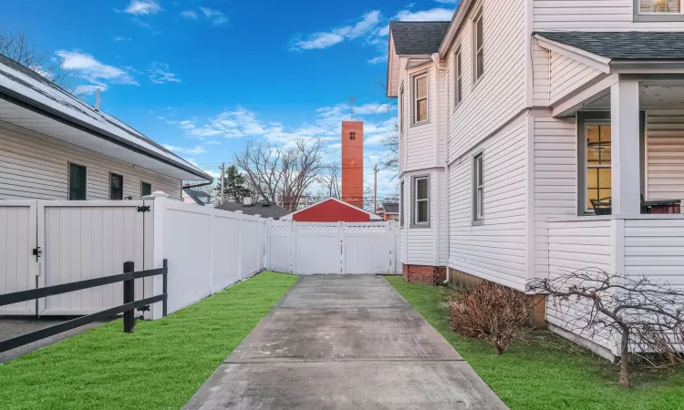 View of side of home featuring a yard