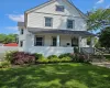 View of front of property with a front yard and a porch