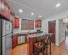 Kitchen with a center island, dark stone countertops, backsplash, and appliances with stainless steel finishes