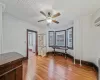 Misc room featuring hardwood / wood-style floors, ceiling fan, and crown molding