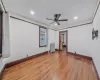 Unfurnished bedroom with ceiling fan, radiator heating unit, dark hardwood / wood-style floors, and ornamental molding