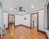 Empty room with radiator, ceiling fan, and hardwood / wood-style flooring