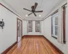 Empty room featuring ceiling fan and dark wood-type flooring