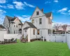 Rear view of property featuring a yard and a patio area