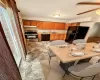 Virtually Staged Kitchen featuring a wealth of natural light, sink, ceiling fan, and black appliances