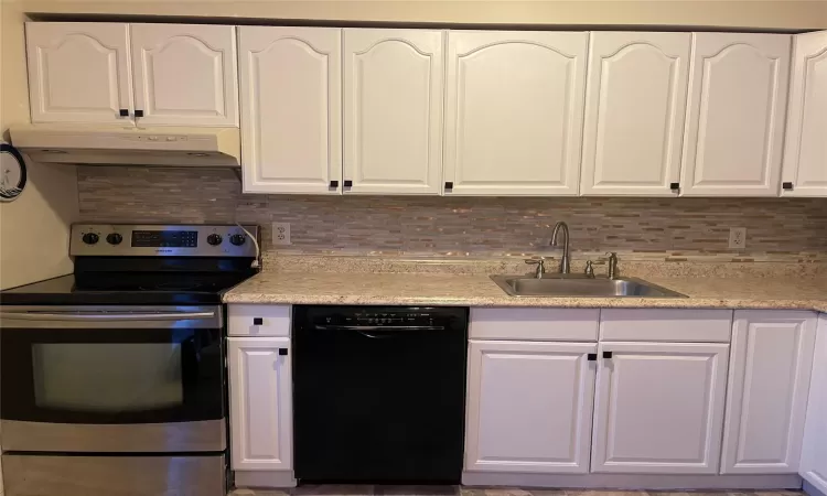 just painted white 1/3/25 Kitchen with white cabinets, dishwasher, and stainless steel electric range oven