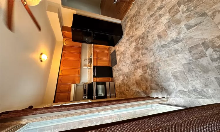 Kitchen with refrigerator, sink, range, black dishwasher, and range hood