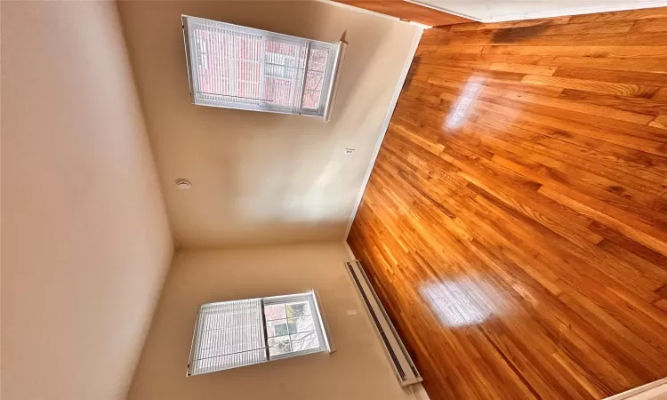 Spare room featuring light wood-type flooring and a baseboard heating unit